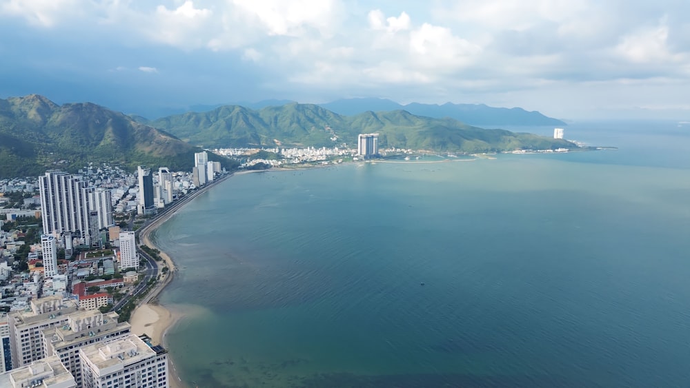 an aerial view of a city next to a large body of water