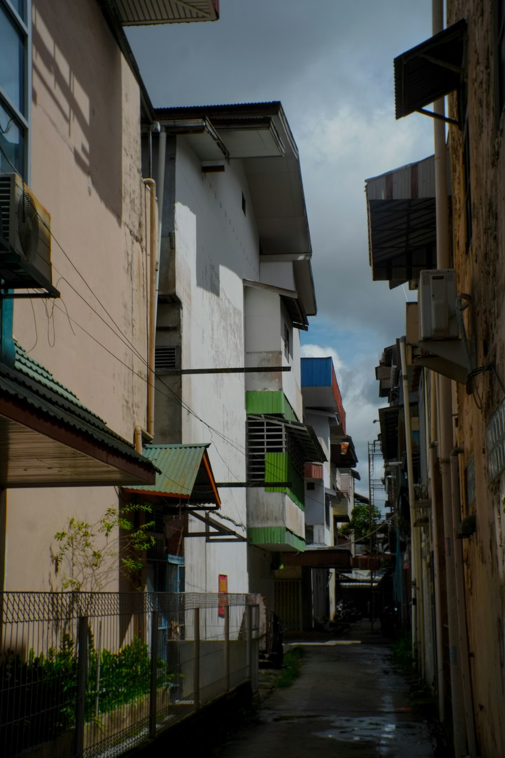 a narrow city street with buildings on both sides