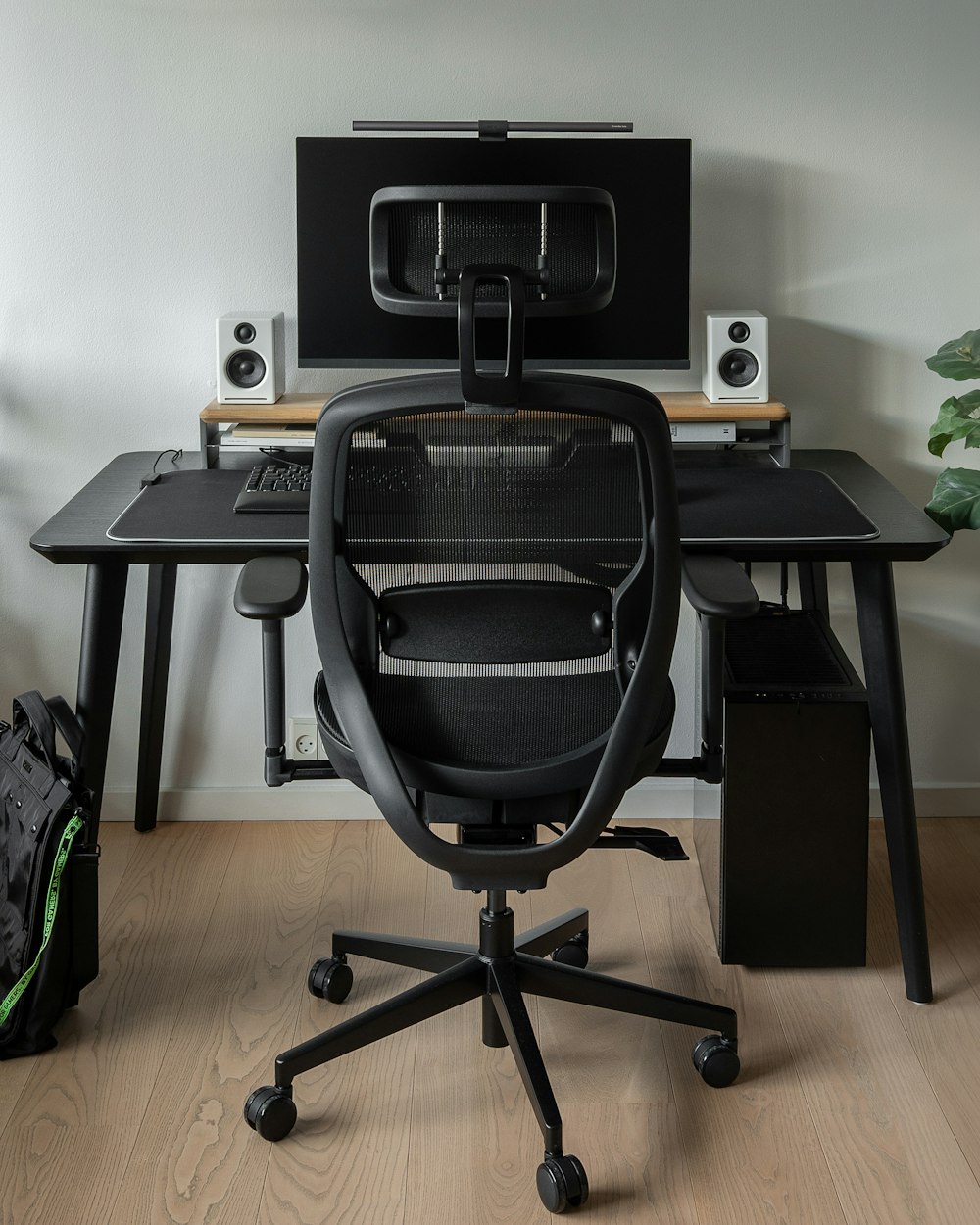 a desk with a chair and a computer on it