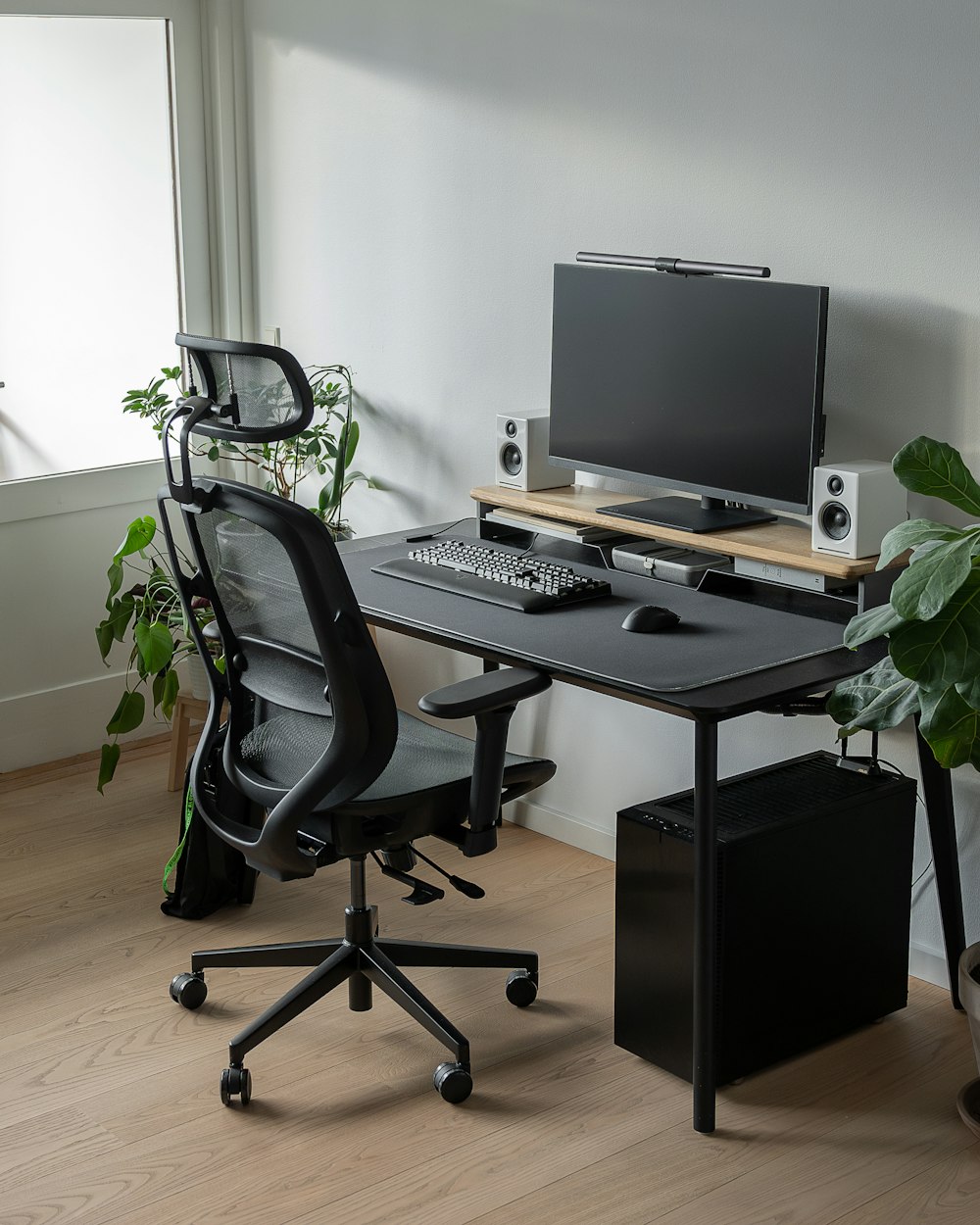 a computer desk with a monitor and keyboard