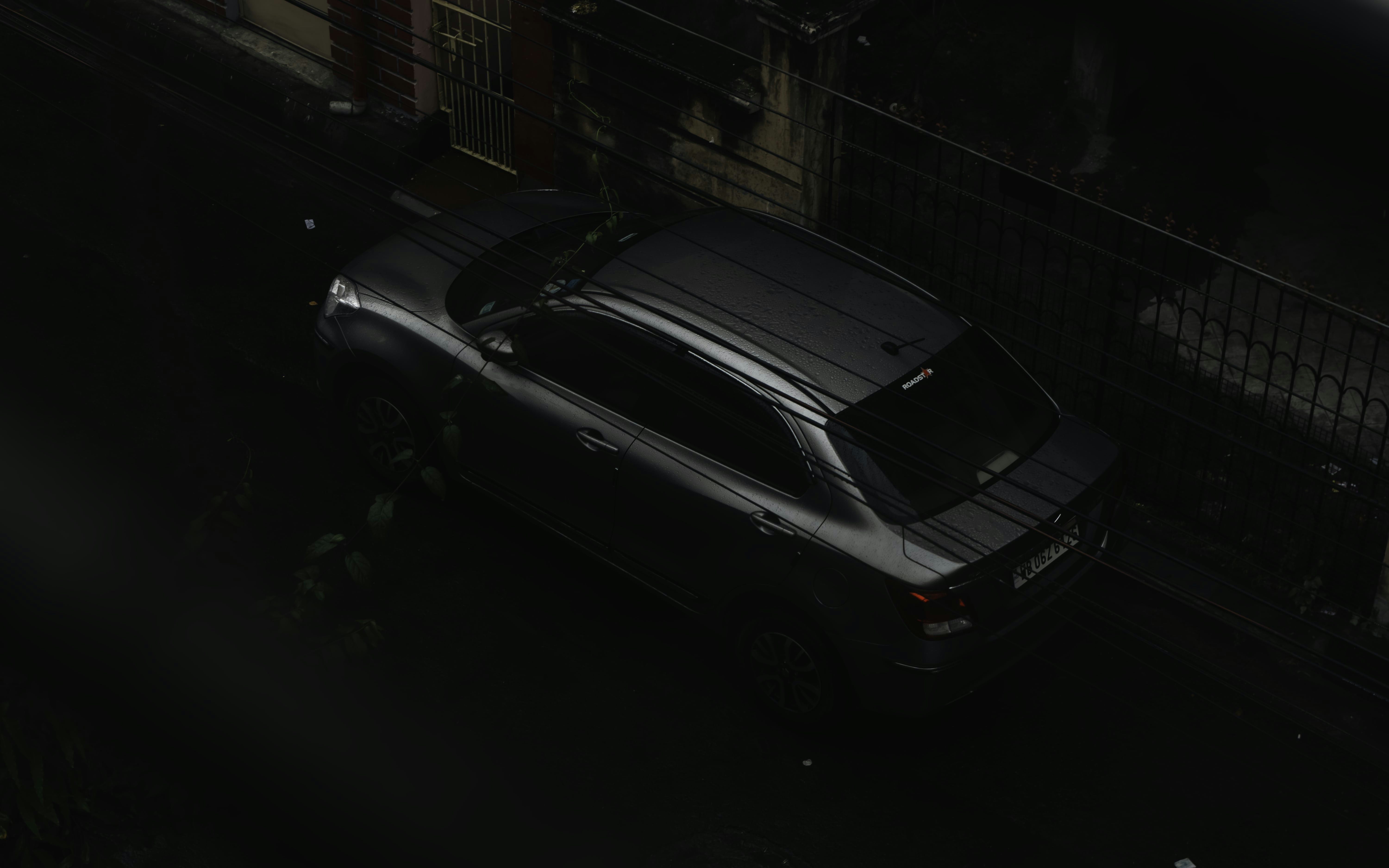 a car parked on the side of the road at night