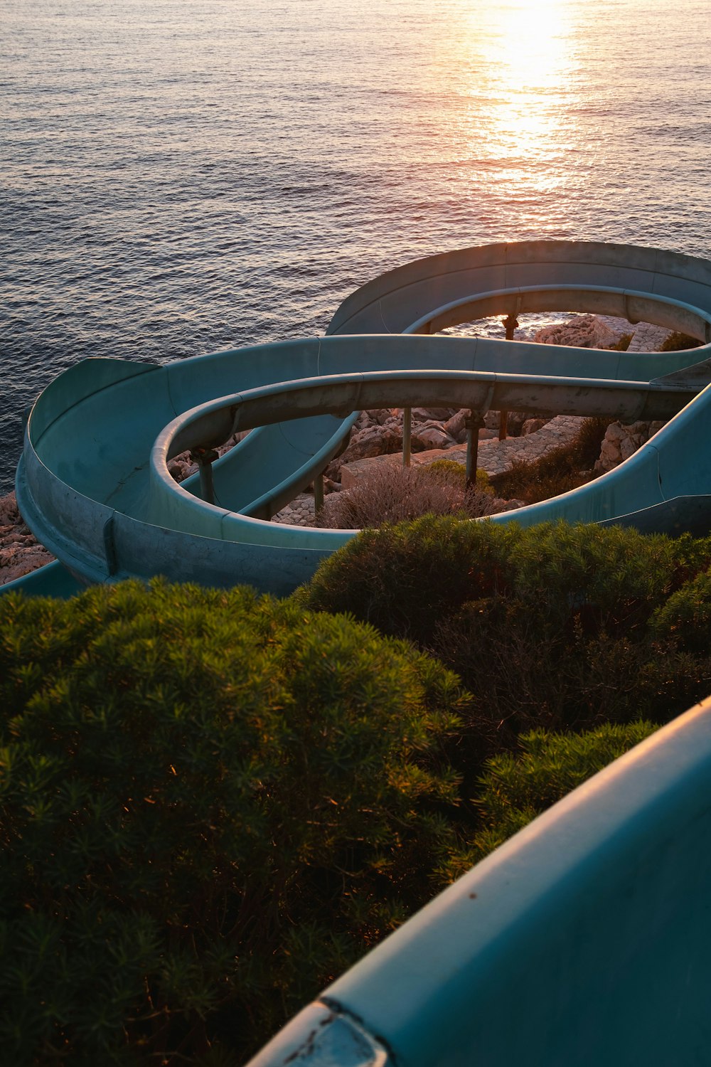 a water slide next to a body of water