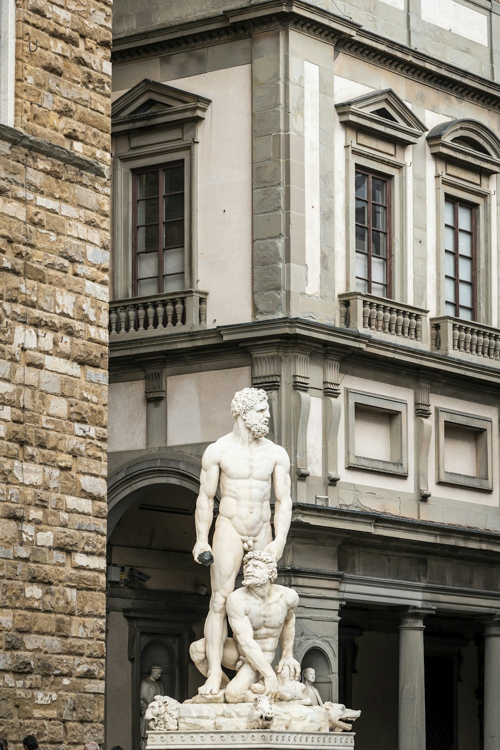 a statue of a man standing next to a building