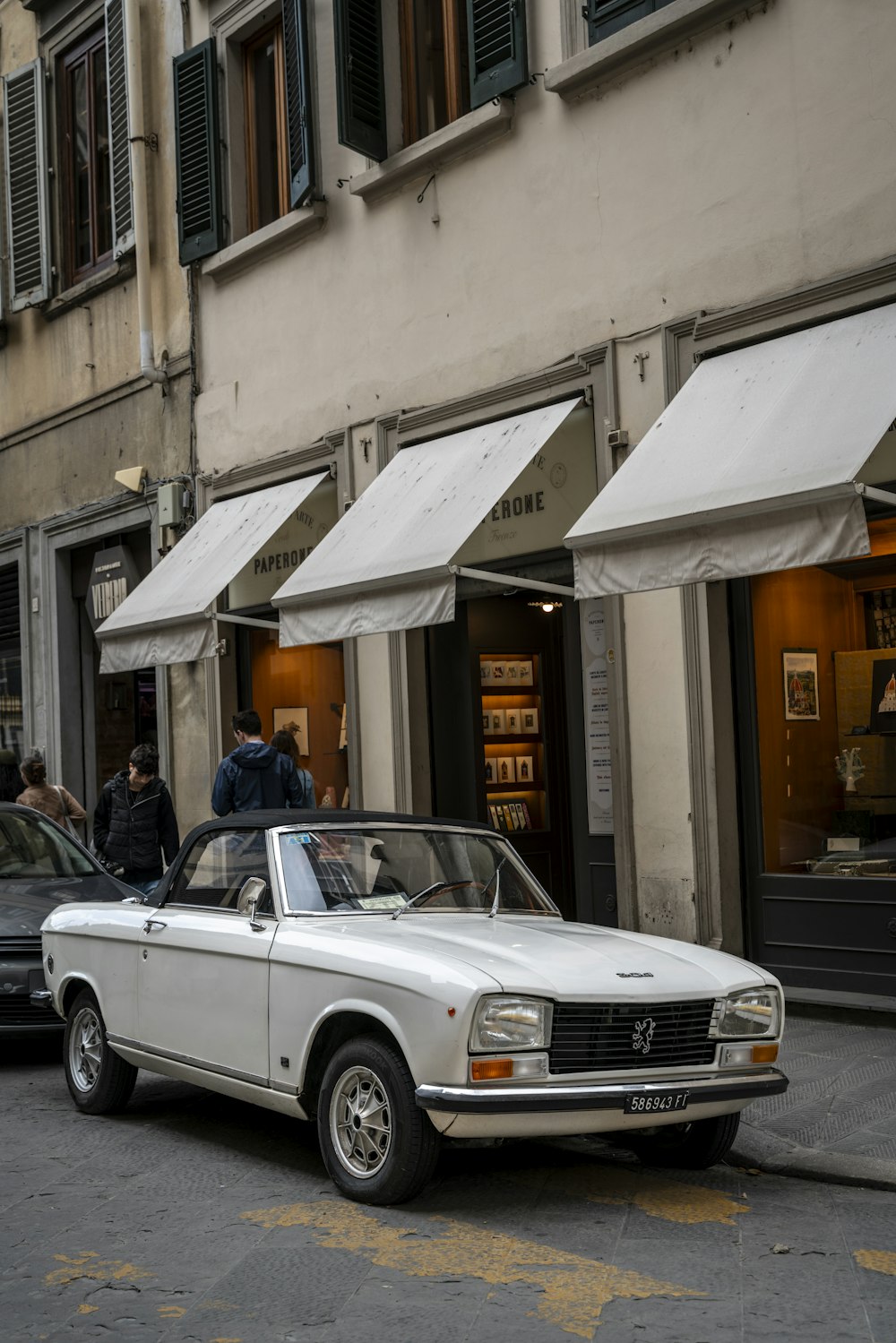 a white car parked on the side of a street