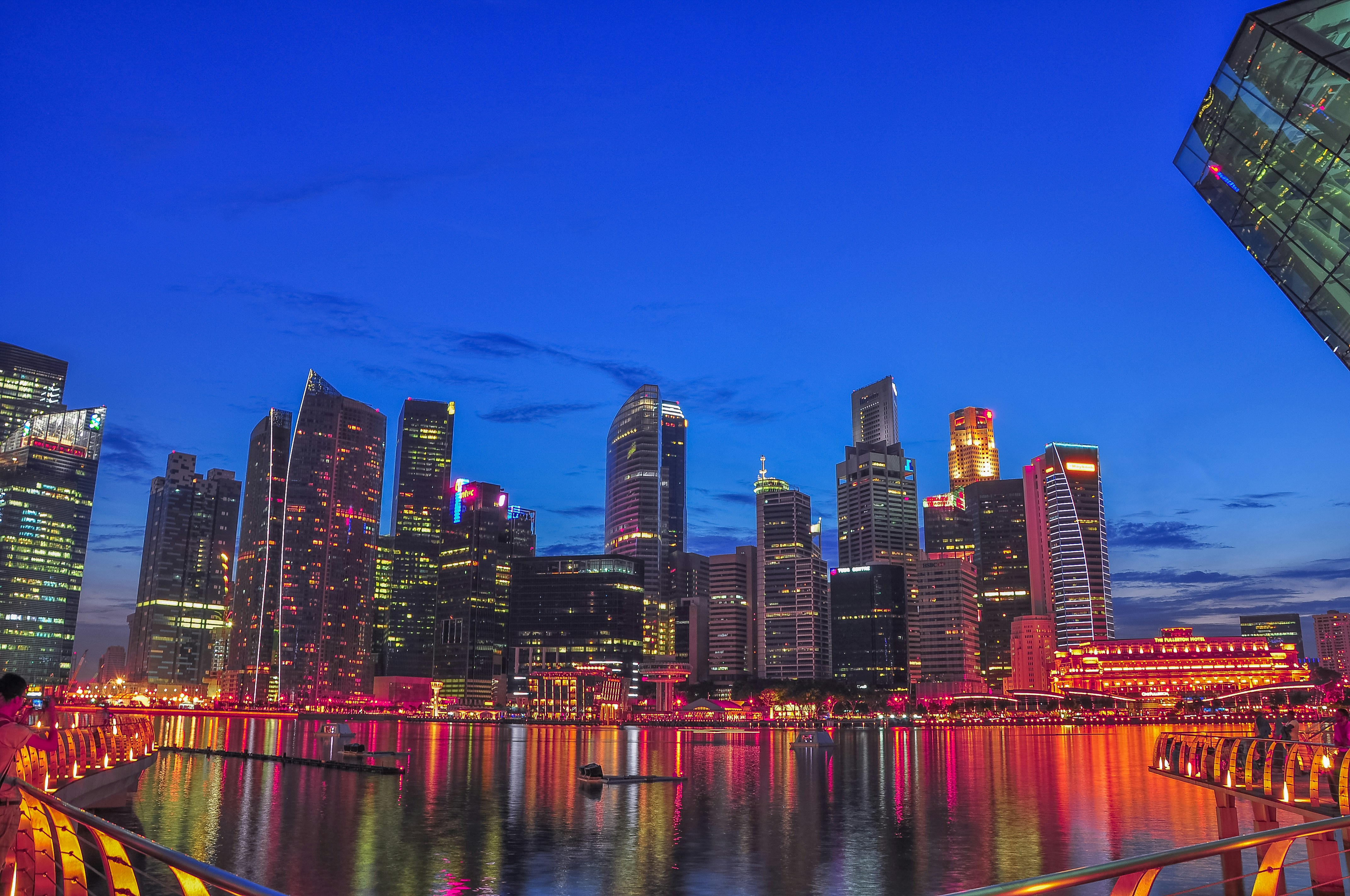 Doha Qatar skyline at night with modern skyscrapers reflecting on water