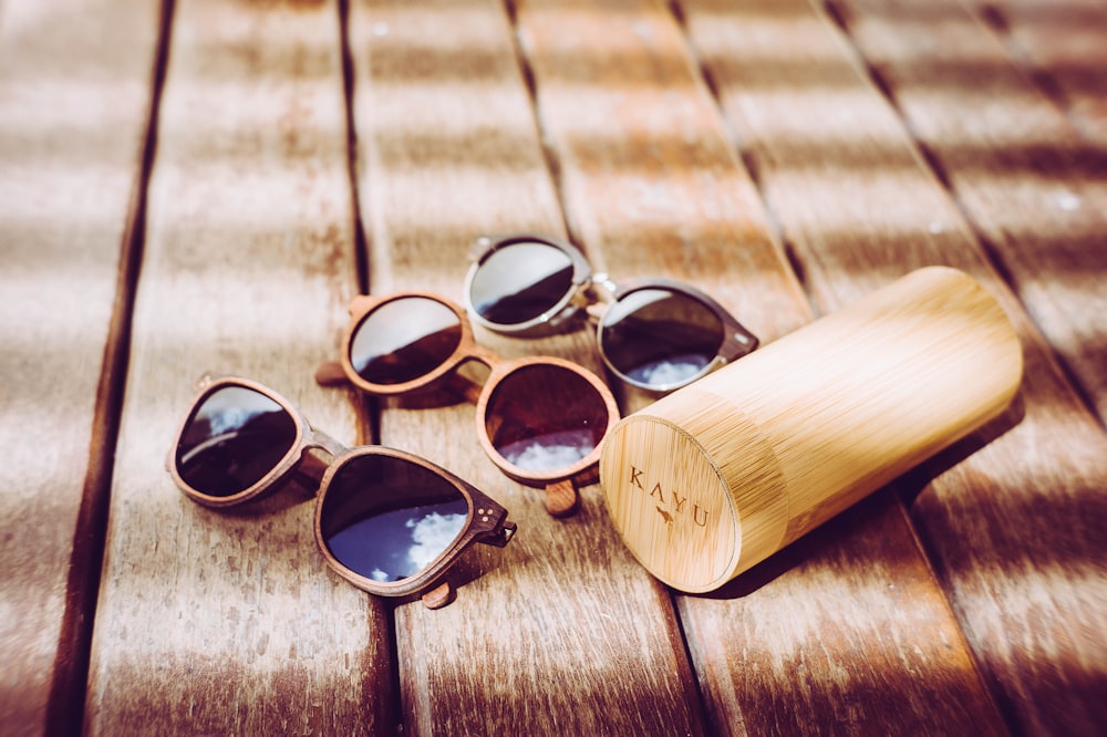 a pair of sunglasses sitting on top of a wooden table