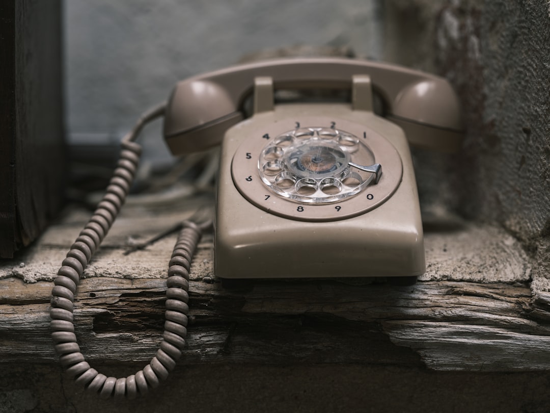 an old fashioned phone sitting on a window sill, old phone