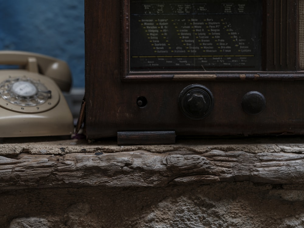 a close up of an old fashioned phone on a ledge
