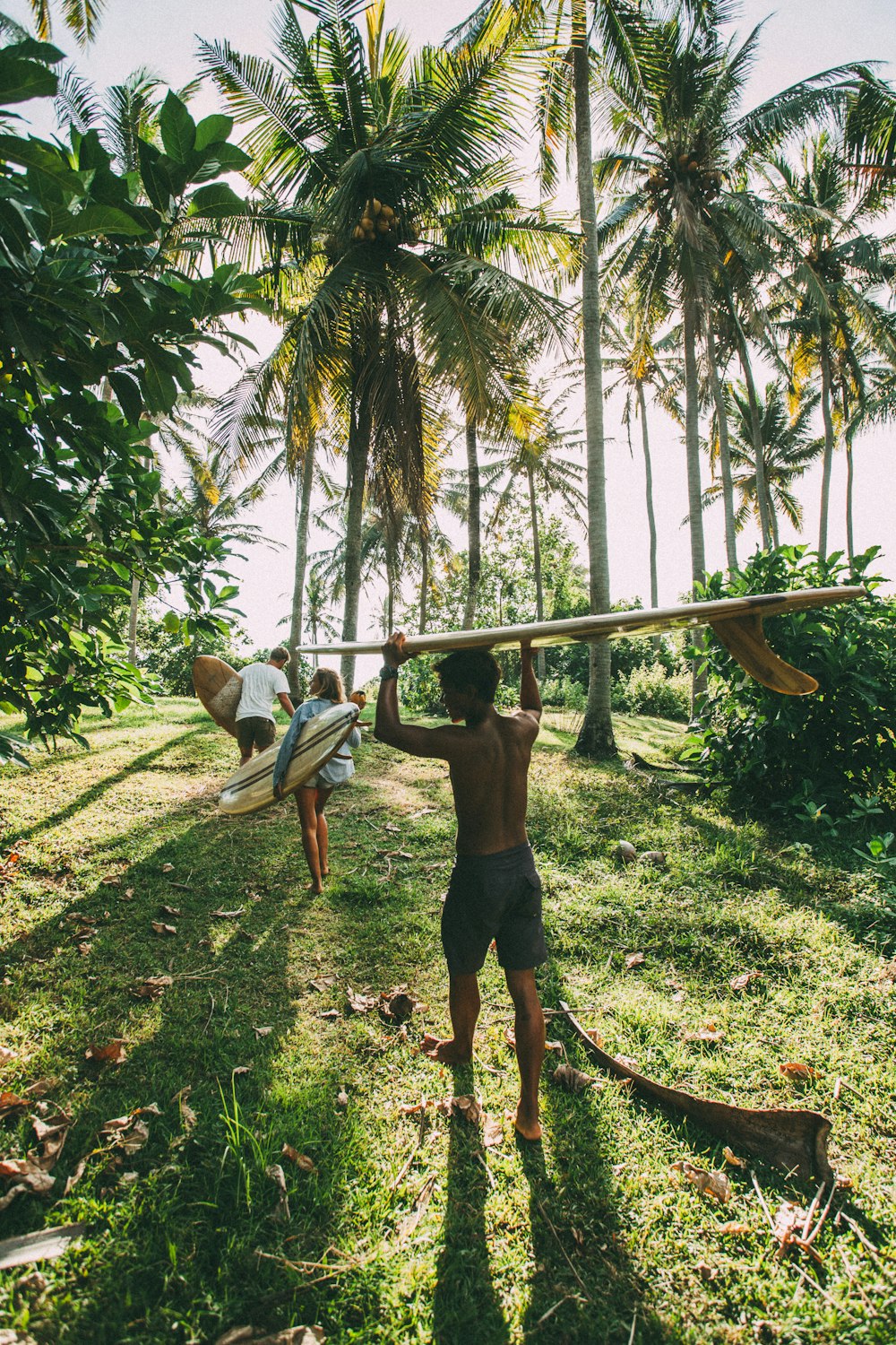 a man holding a surfboard over his head