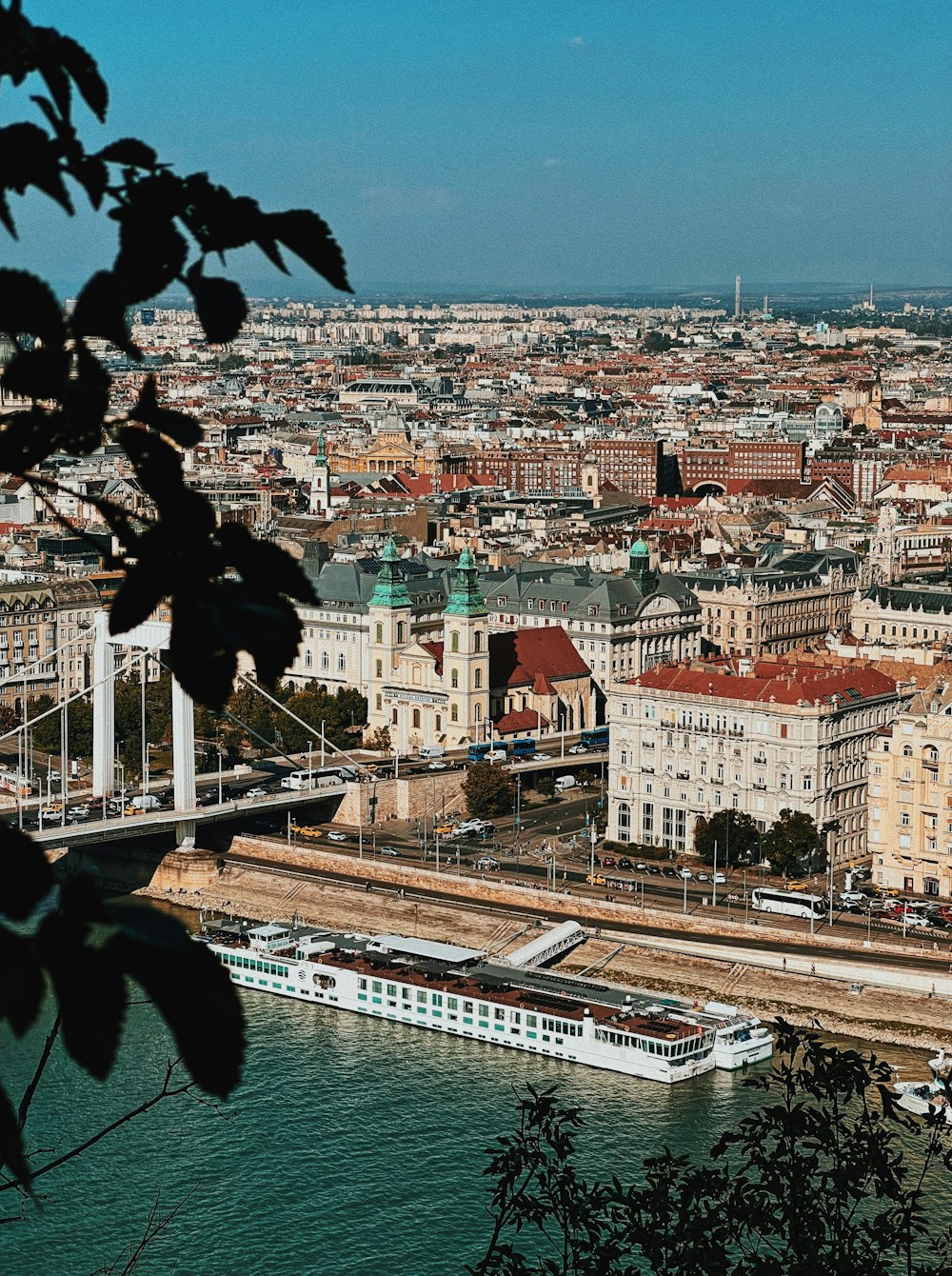 a view of a city from a hill above the water