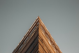 a tall wooden building with a clock on the top of it