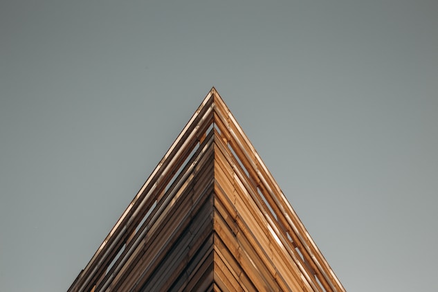 a tall wooden building with a clock on the top of it