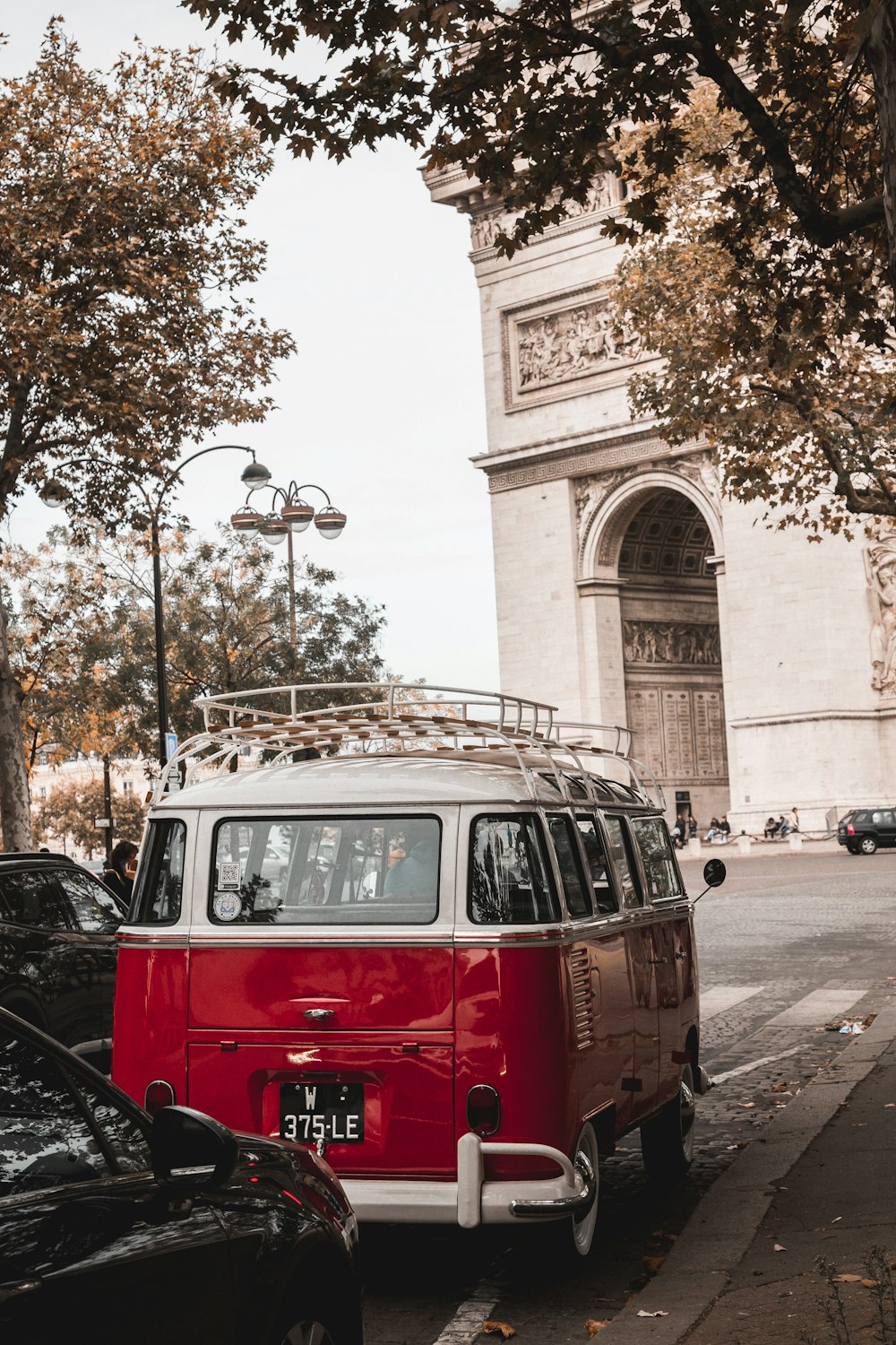 a red and white van parked on the side of the road