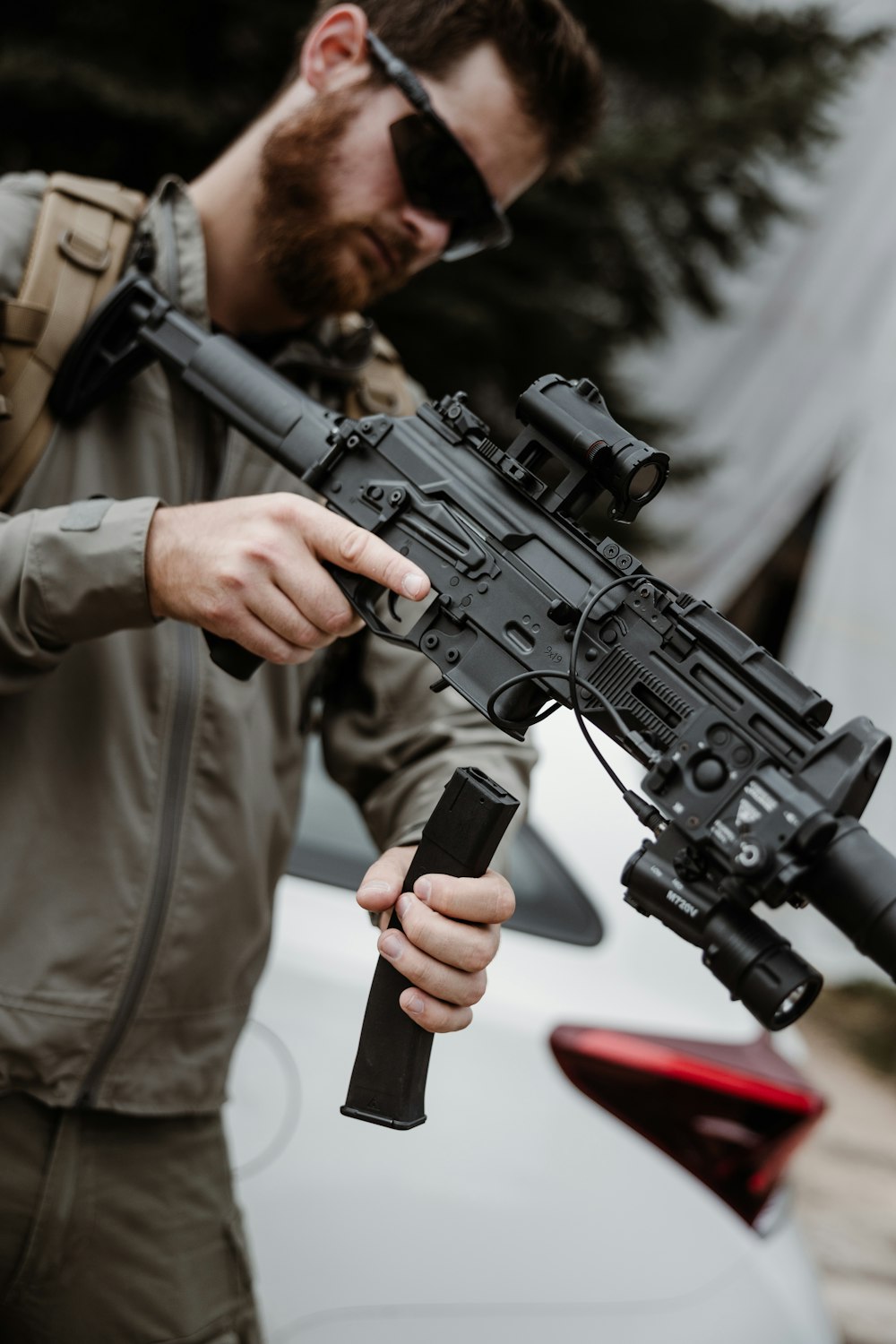 a man holding a gun and a cell phone