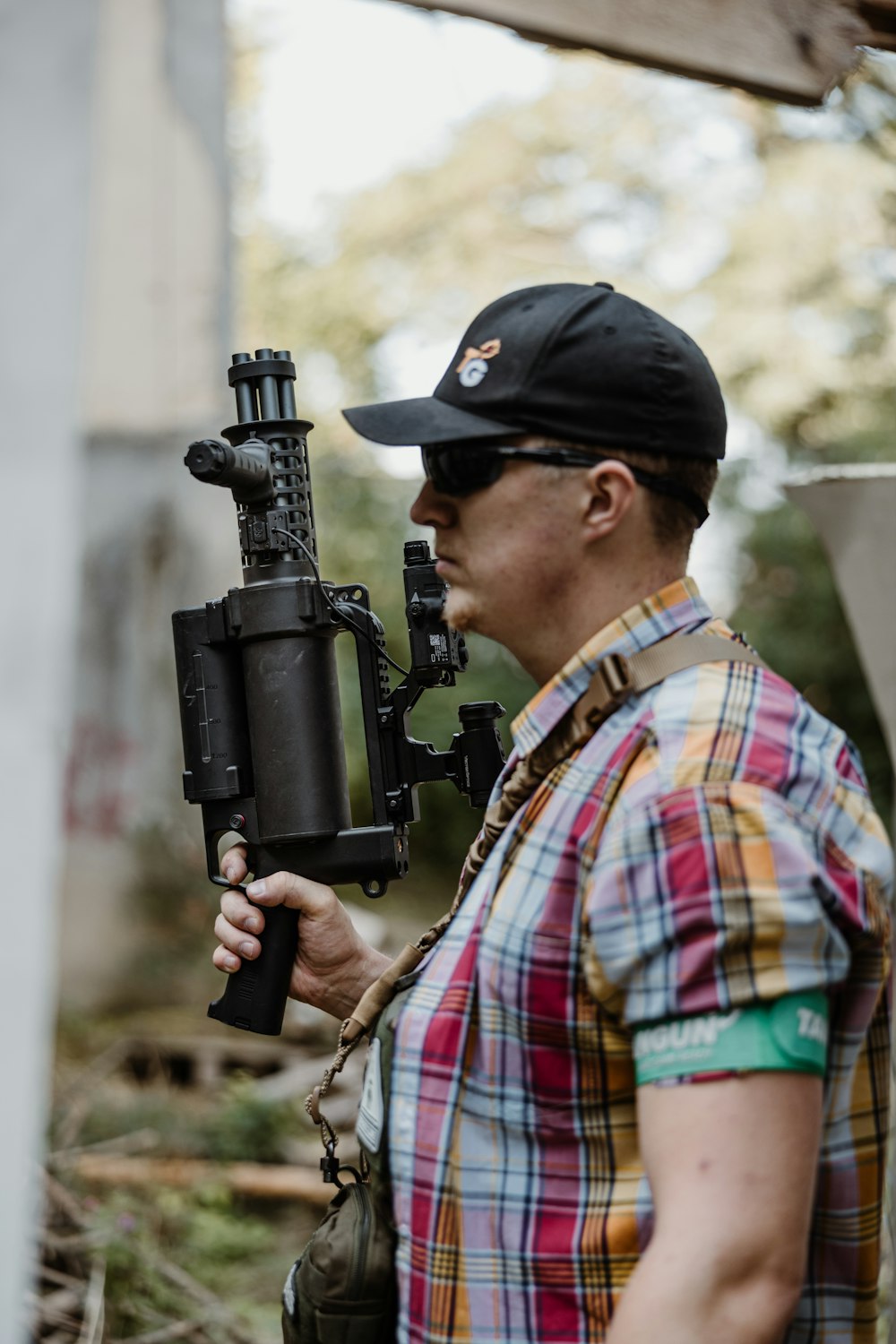 a man holding a camera and a gun