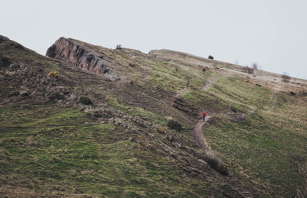 a person is walking up a steep hill