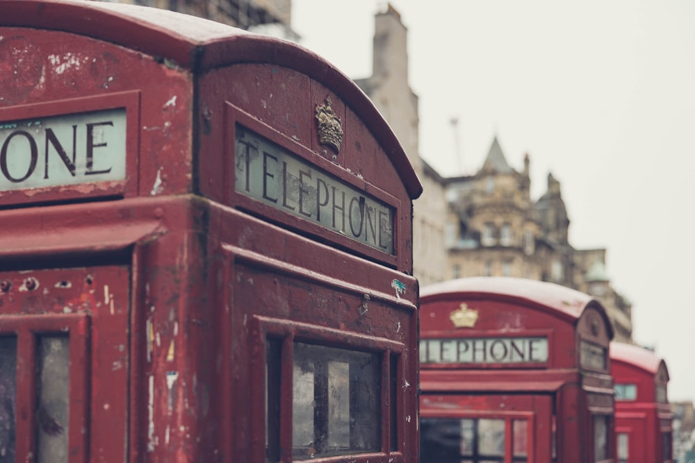 a row of red telephone booths sitting next to each other