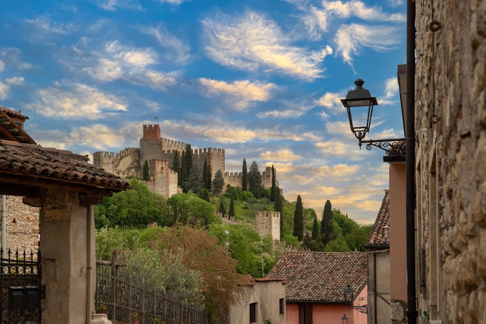 a street light in front of a castle on a hill