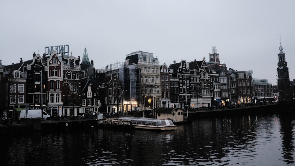 a row of buildings next to a body of water