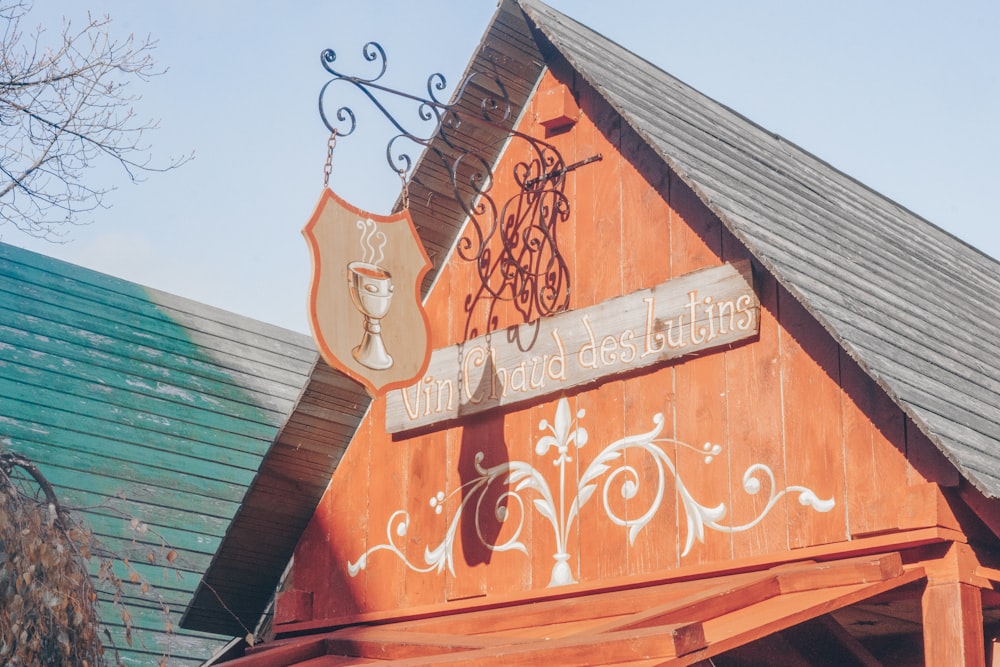 a wooden building with a sign on the side of it