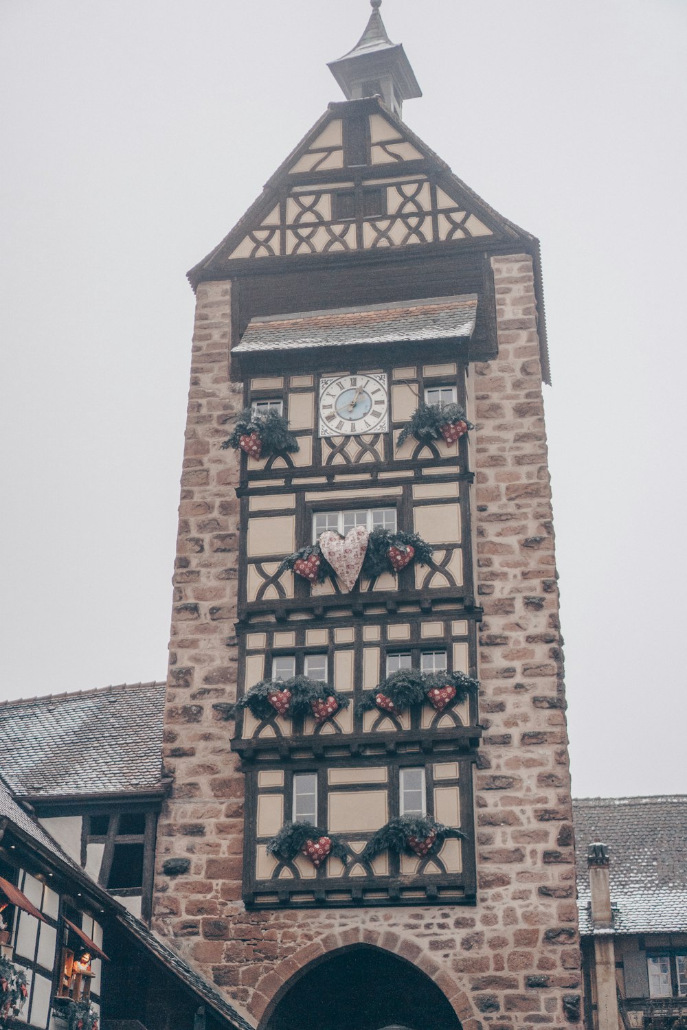 a tall brick building with a clock on it's side