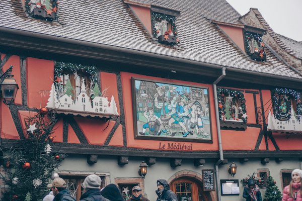 A painted half-timbered façade in Riquewihr — France