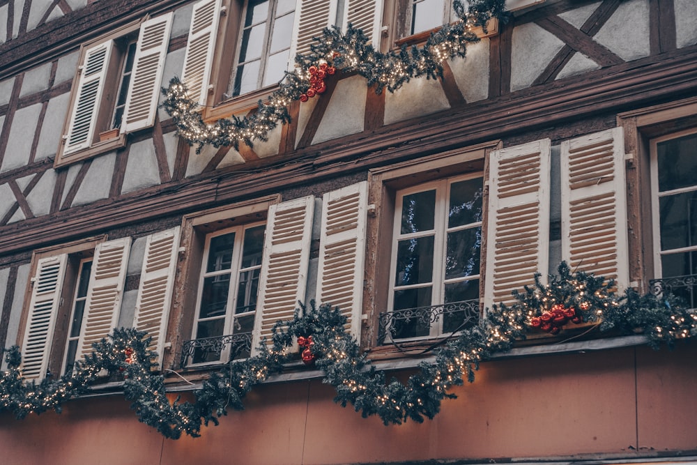 a building with christmas decorations on the windows