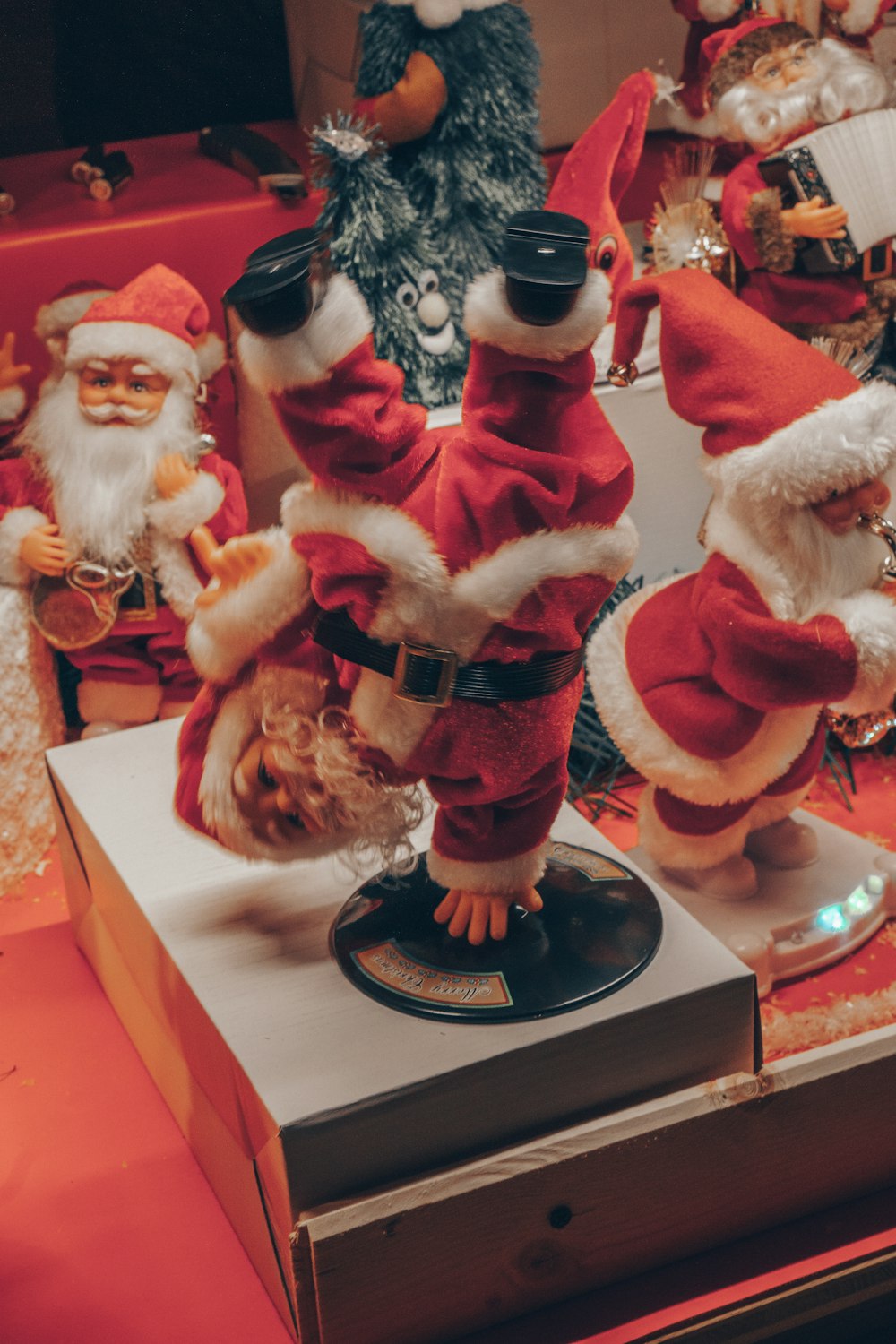 a group of santa clause figurines sitting on top of a table