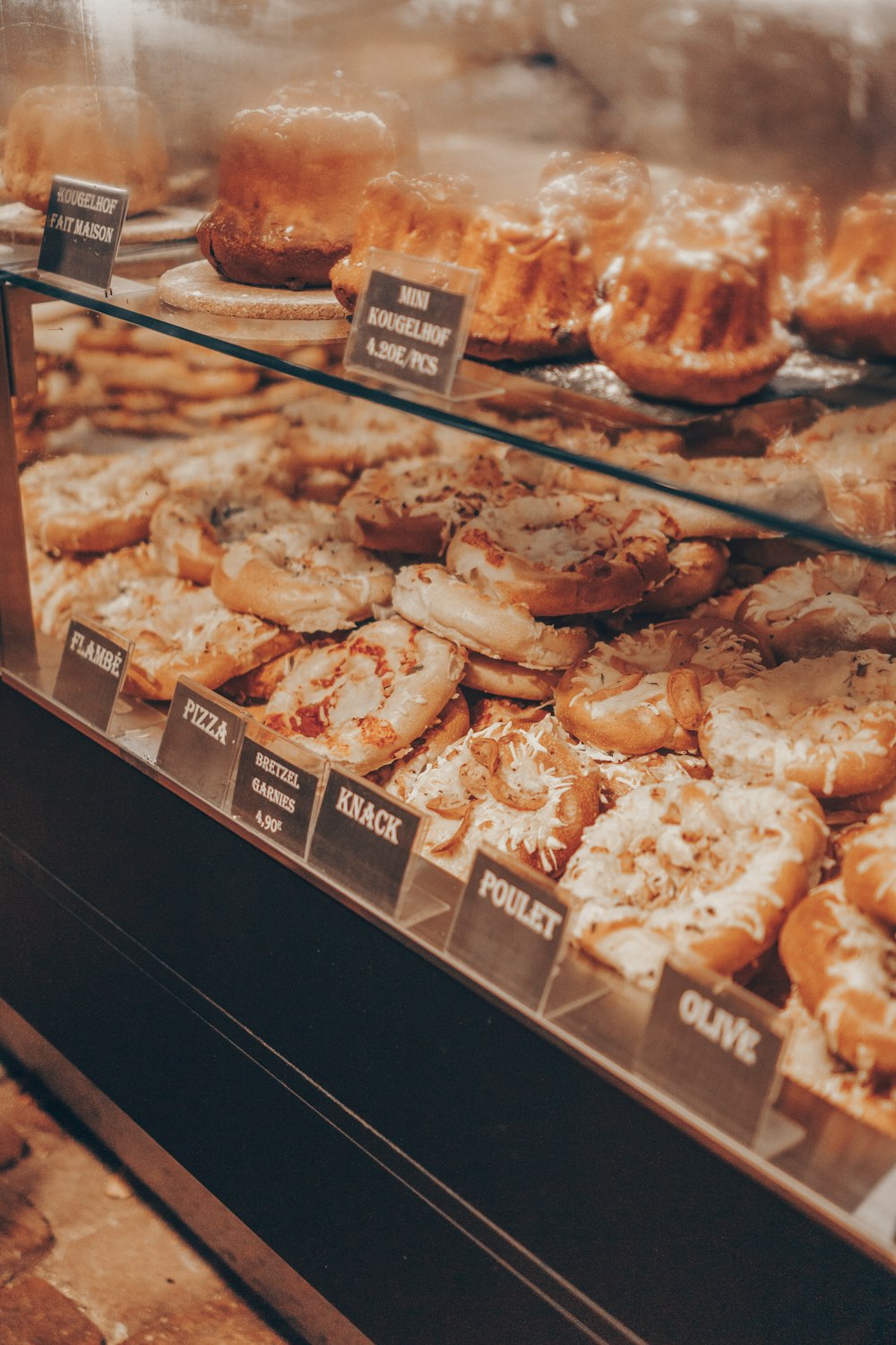 a display case filled with lots of different kinds of doughnuts