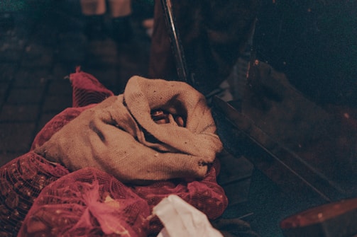 A sack of animal feed surrounded by fresh farm produce.