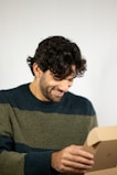 A cheerful customer unboxing a package with a smile.