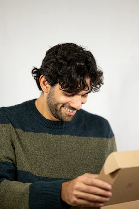 Smiling customer unboxing a varejovivo package at home