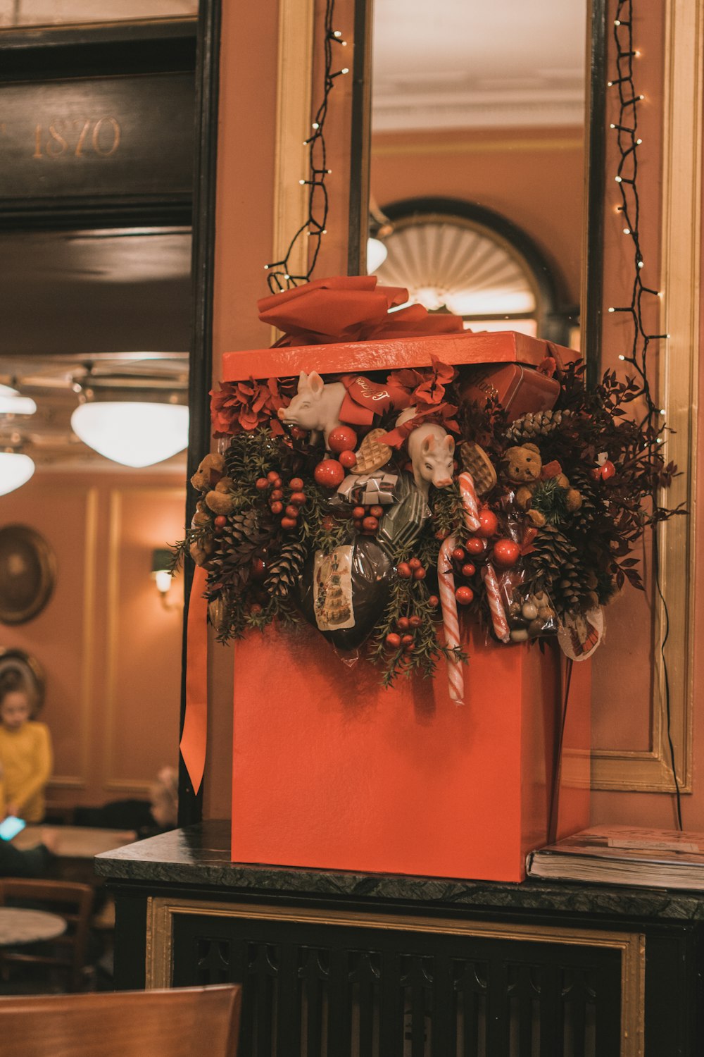 a red box with a wreath on top of it