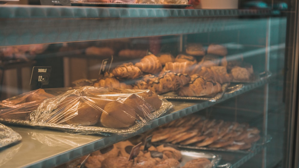 a bakery display case filled with lots of pastries