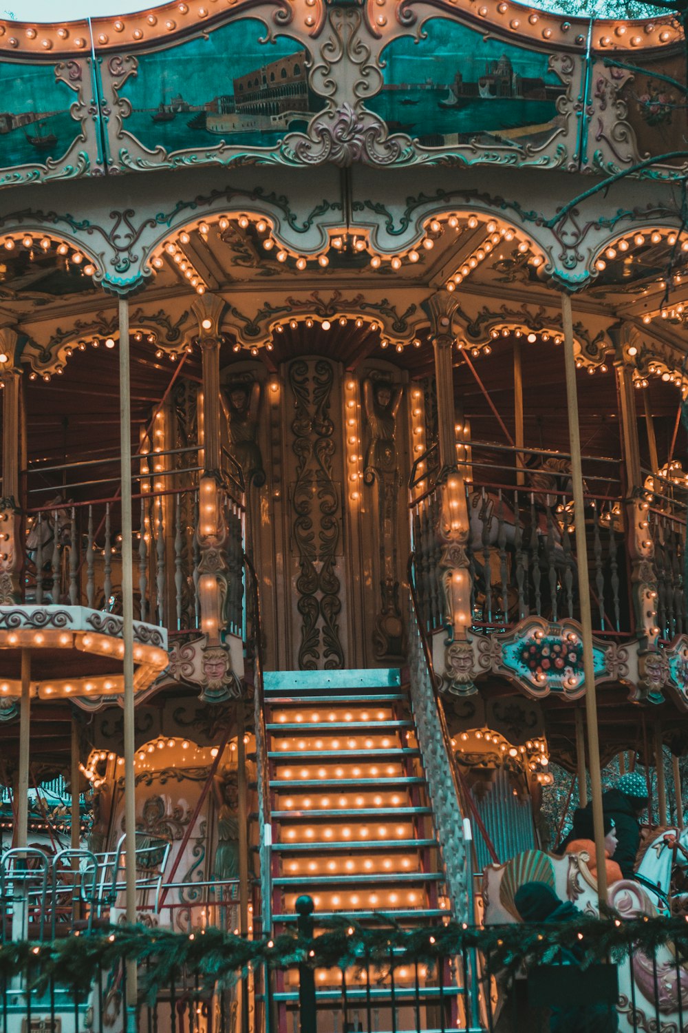 a merry go round with lights and a staircase