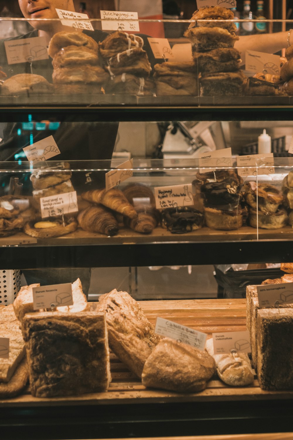 a display case filled with lots of different types of doughnuts