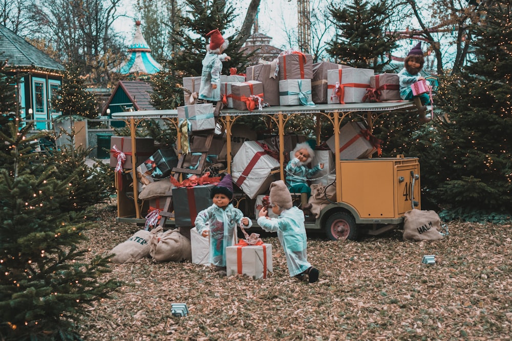 a group of children standing in front of a christmas tree