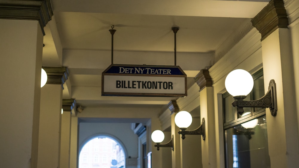 a sign hanging from the ceiling of a hallway