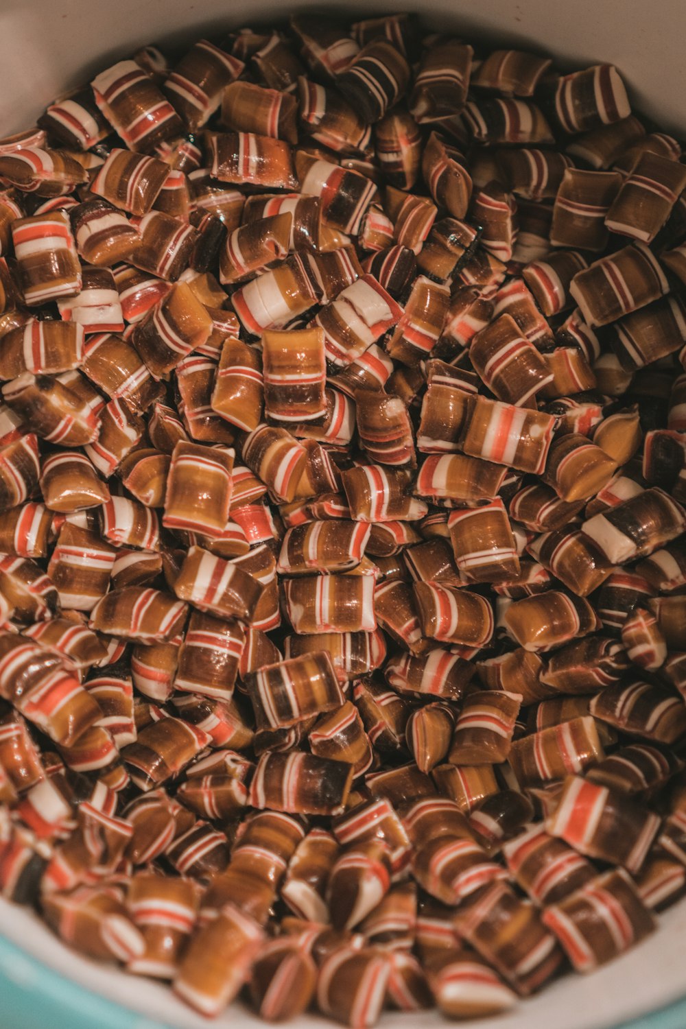 a bowl filled with lots of brown and white candy