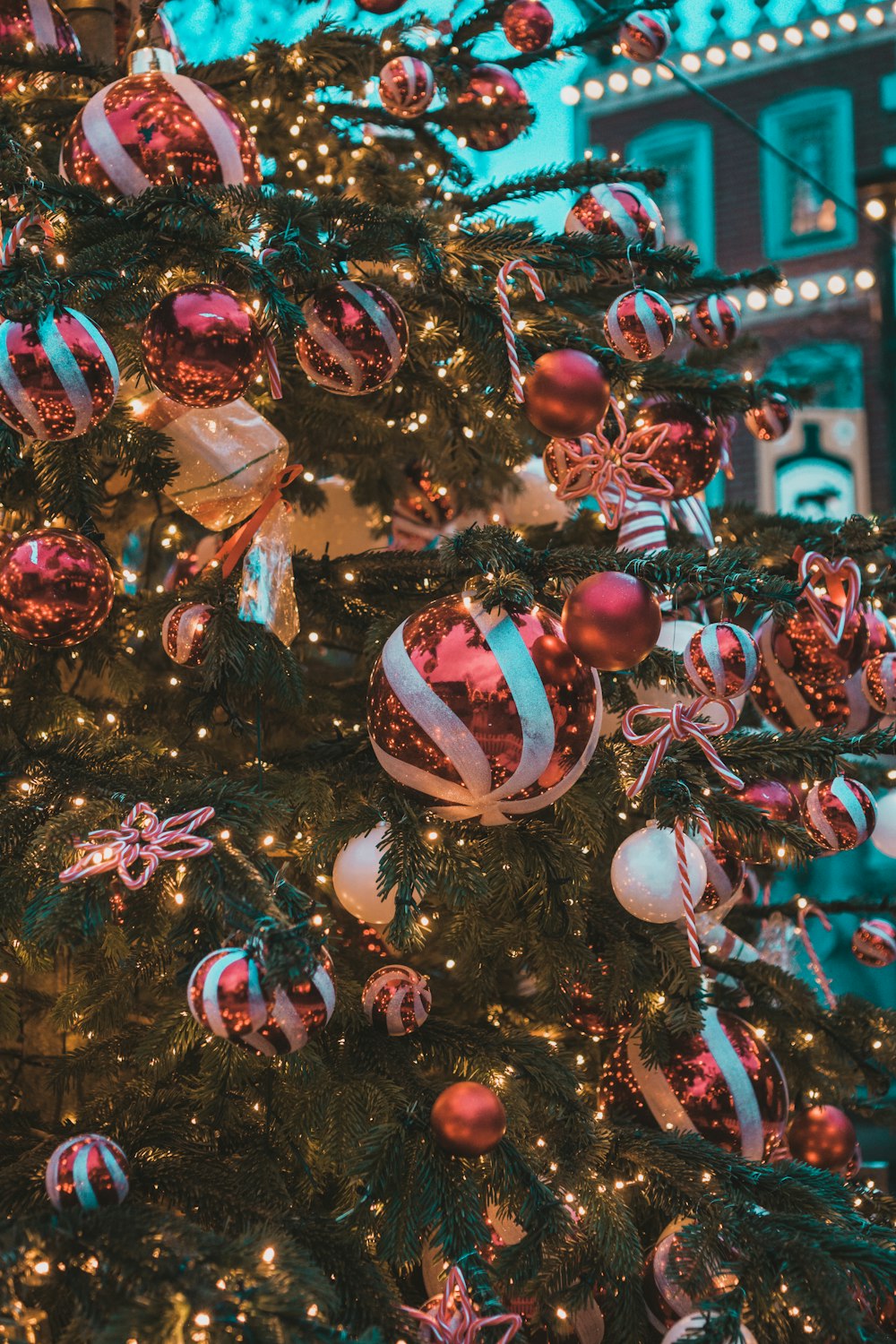 a decorated christmas tree in front of a building