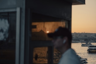 A warm photo of a traveler reflecting peacefully at a mosque during sunset.