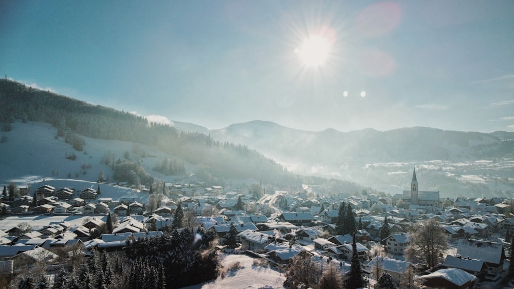 the sun shines brightly over a snowy town