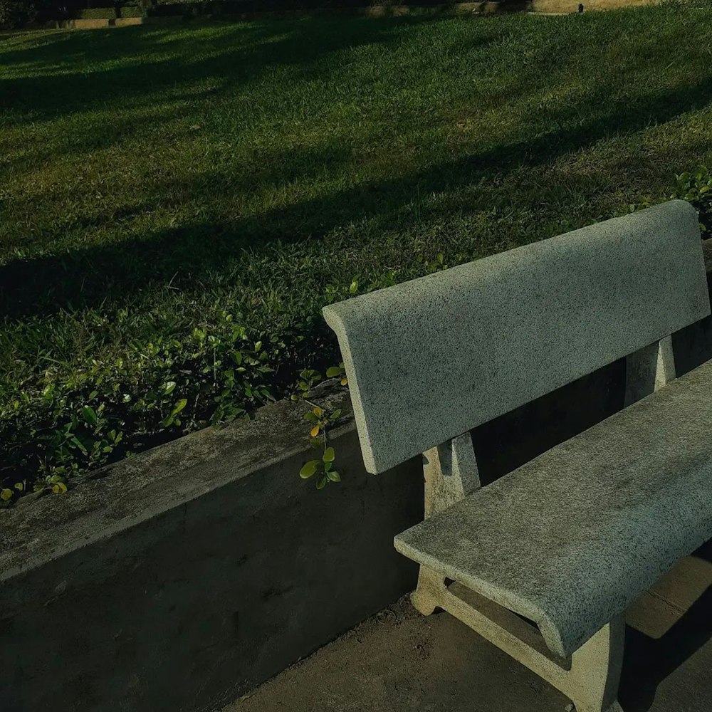 a concrete bench sitting next to a cement wall