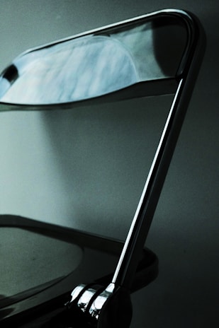 Close-up of a sleek foldable chair showing its durable fabric and metal frame.