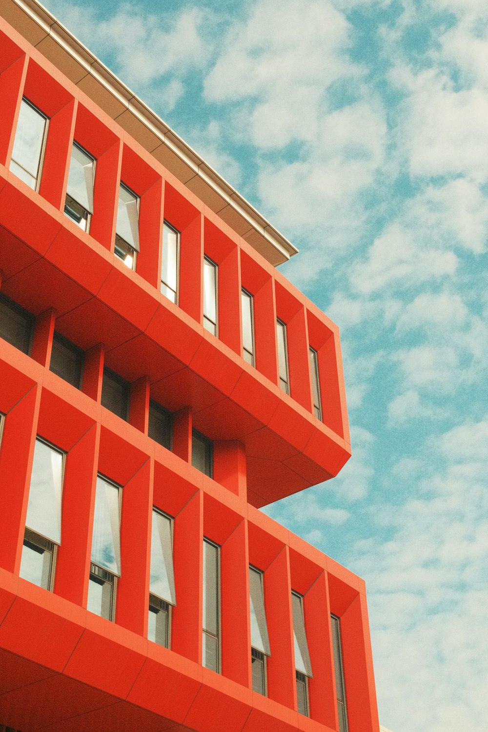 a tall red building with lots of windows