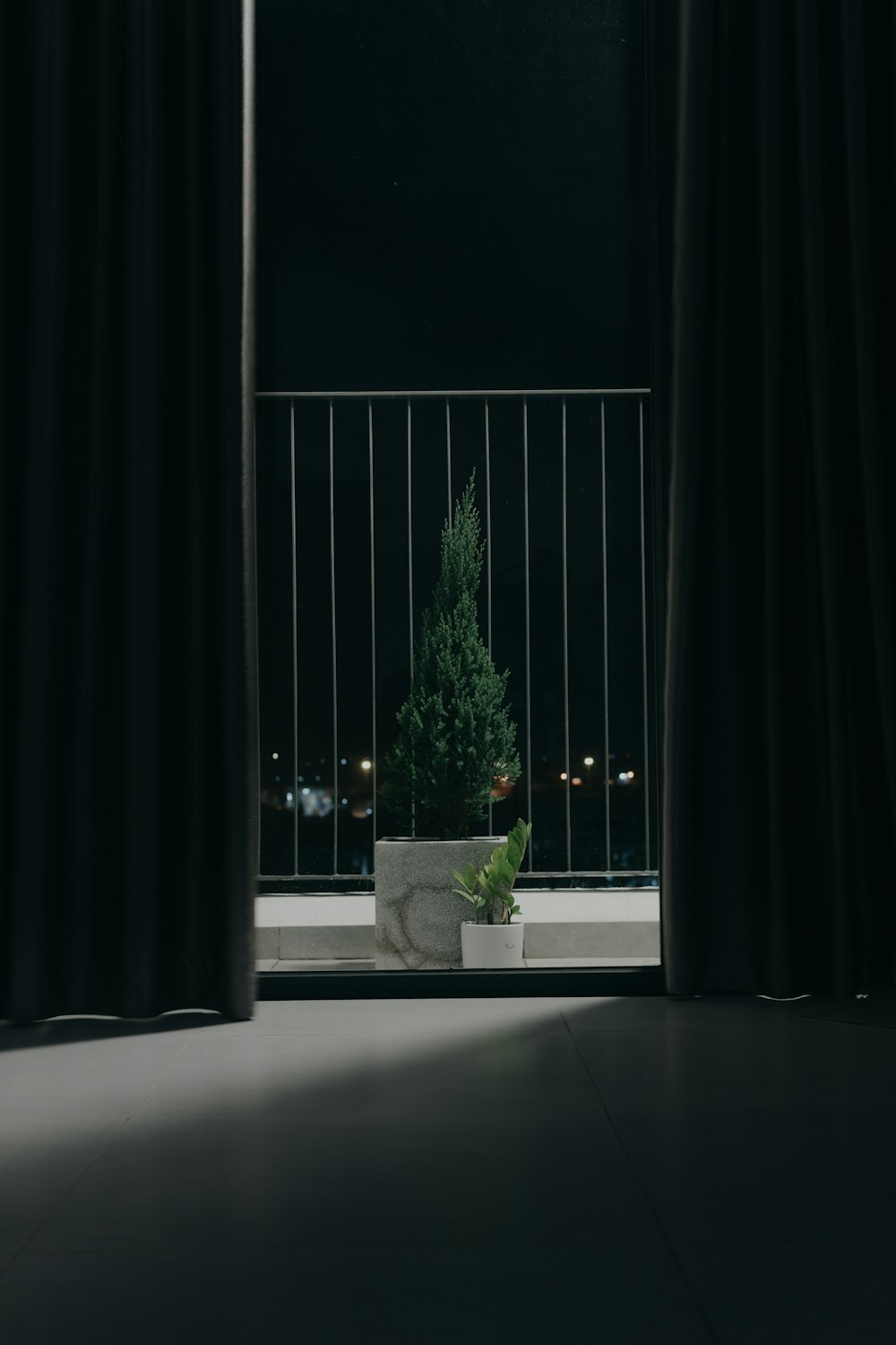 a plant in a planter sitting in front of a window