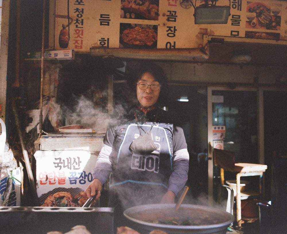 a woman standing in front of a food stand