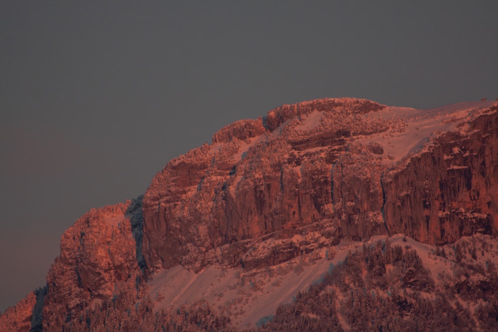 a snowy mountain with a full moon in the sky