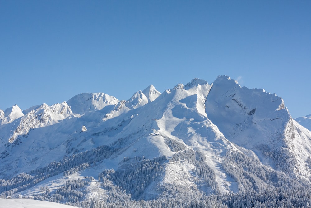 a snow covered mountain with a ski lift in the foreground