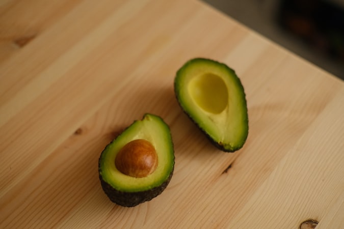 an avocado cut in half on a cutting board